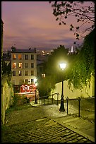 Hillside stairs, street lights, and Eiffel Tower in the distance, Montmartre. Paris, France (color)