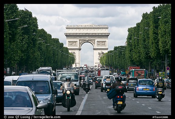 Car and motorcycle traffic and Arc de Triomphe, Champs-Elysees. Paris, France