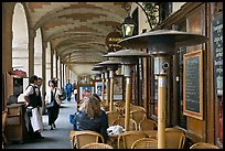 Outdoor cafe tables and heating lamps, place des Vosges. Paris, France (color)