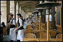 Waiters and cafe in place Victor Hugo arcades. Paris, France (color)