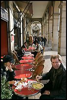 Couple eating at an outdoor table in the Palais Royal arcades. Paris, France