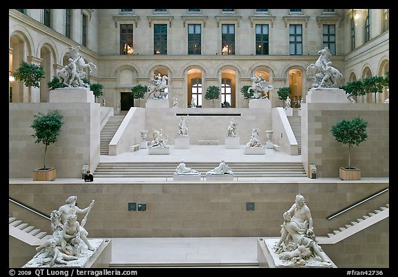 Ancient sculptures in display in Louvre Museum room. Paris, France (color)