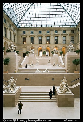 Tourists and exhibit inside Louvre museum. Paris, France (color)