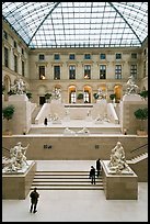 Tourists and exhibit inside Louvre museum. Paris, France (color)