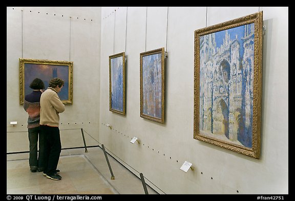 Tourists looking at Monet's Rouen Cathedral, Orsay Museum. Paris, France