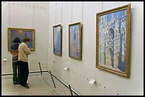 Tourists looking at Monet's Rouen Cathedral, Orsay Museum. Paris, France ( color)