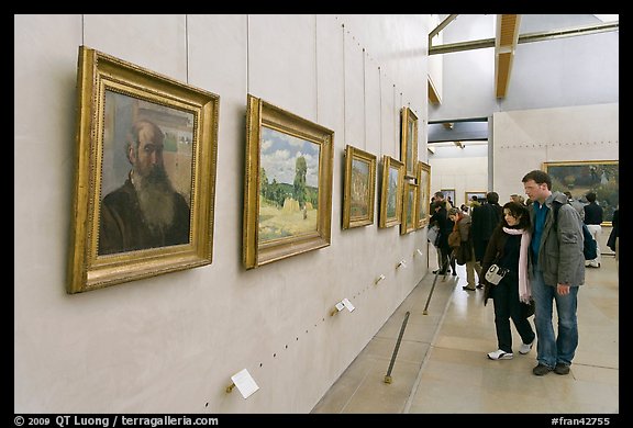 Couple looking at impressionists paintings, Orsay Museum. Paris, France