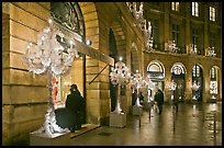 Looking at the storefronts of luxury stores at night, Place Vendome. Paris, France