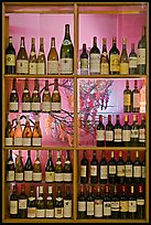 Wine bottles in storefront, passage Vivienne. Paris, France