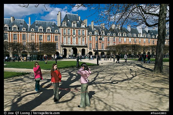 Girls playing in park, Place des Vosges. Paris, France