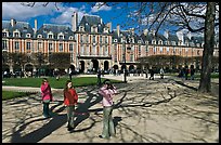 Girls playing in park, Place des Vosges. Paris, France