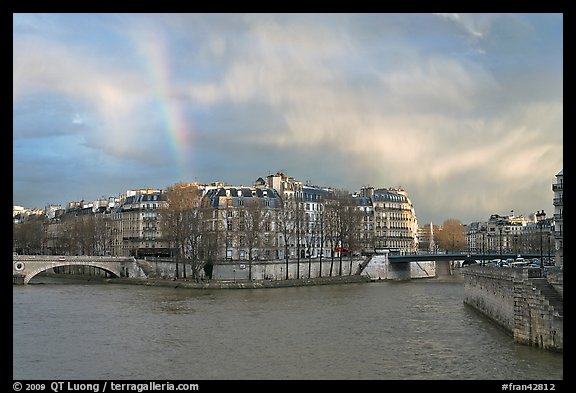 Clearing storm with rainbow above Saint Louis Island. Paris, France