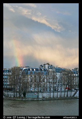 Riverfront houses on Ile Saint Louis with rainbow. Paris, France