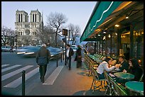 Cafe, street, and Notre Dame at dusk. Quartier Latin, Paris, France (color)