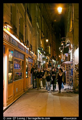 People walking in pedestrian street at night. Quartier Latin, Paris, France (color)
