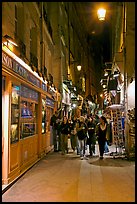 People walking in pedestrian street at night. Quartier Latin, Paris, France ( color)