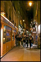 People walking in pedestrian street at night. Quartier Latin, Paris, France ( color)