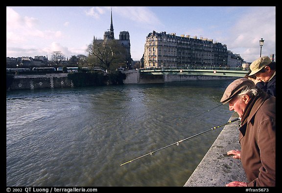 Fishermen on ile Saint Louis, with ile de la Cite in the background. Paris, France