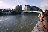 Fishermen on ile Saint Louis, with ile de la Cite in the background. Paris, France