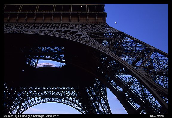 Base of Tour Eiffel (Eiffel Tower) with moon. Paris, France