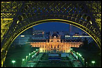 Ecole Militaire (Military Academy) seen through Eiffel Tower at night. Paris, France ( color)