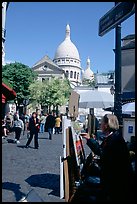 Painter on Place du Tertre, with the Sacre Coeur in the background, Montmartre. Paris, France (color)