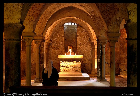 Crypte of the Romanesque church of Vezelay with Nun in prayer. Burgundy, France (color)