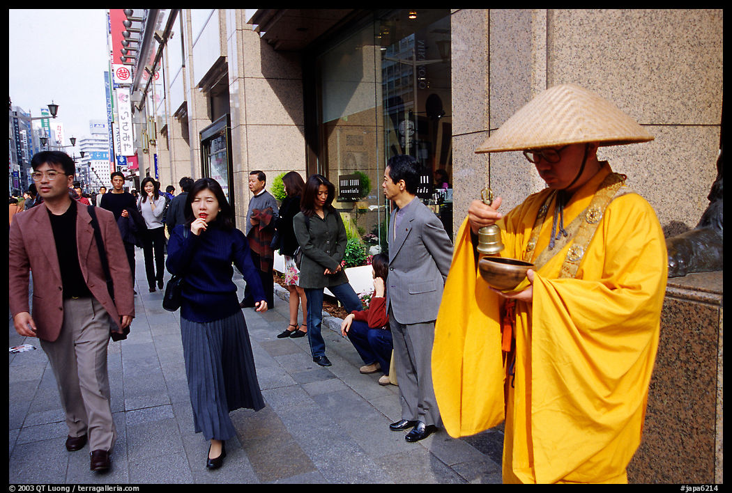 Buddhist monk seeking alms in front of a Ginza department store. Tokyo, Japan