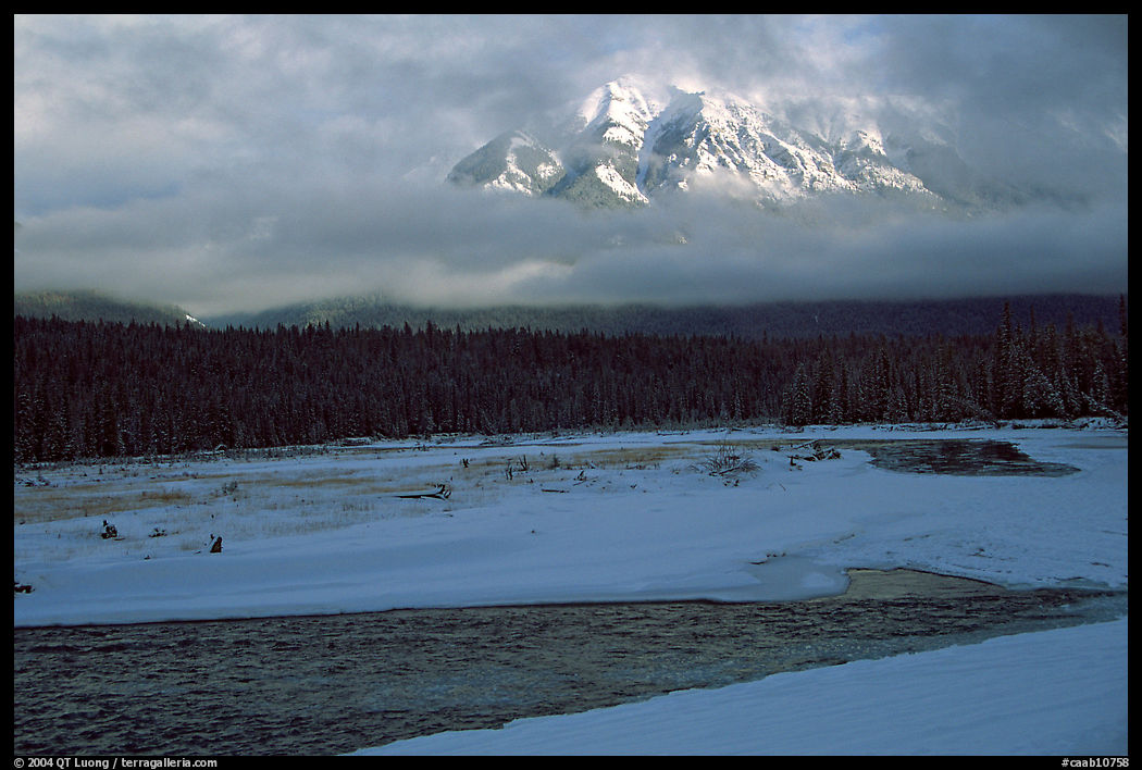 River, snow, and peak emerging from clouds. Banff National Park, Canadian Rockies, Alberta, Canada