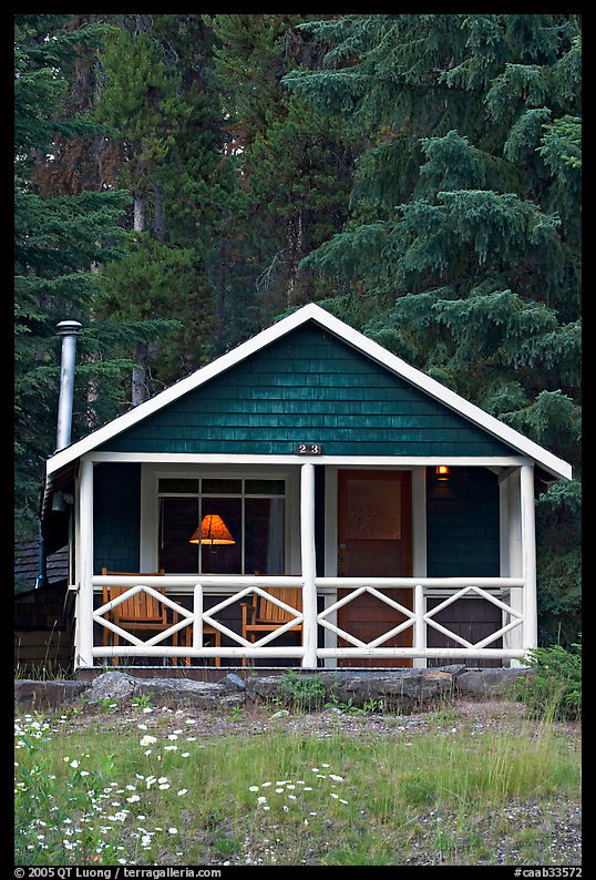 Cabin in the woods with interior lights. Banff National Park, Canadian Rockies, Alberta, Canada