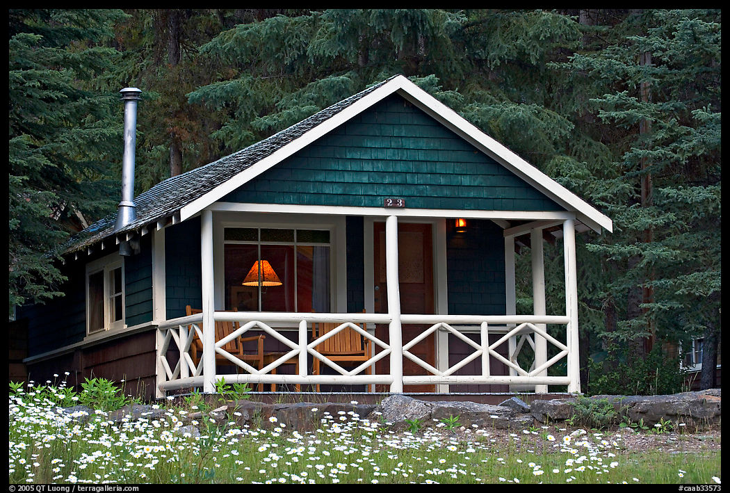 Cabin in forest with interior lights. Banff National Park, Canadian Rockies, Alberta, Canada