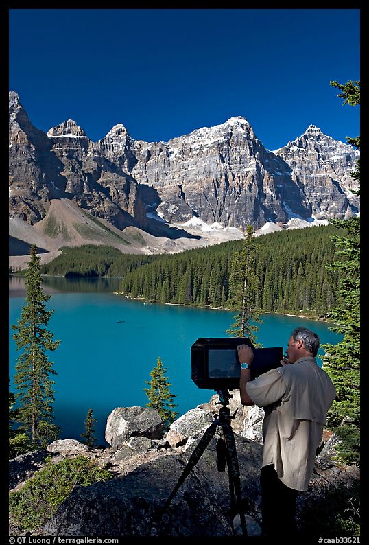 Photographer operating a 8x10 view camera at Moraine Lake. Banff National Park, Canadian Rockies, Alberta, Canada