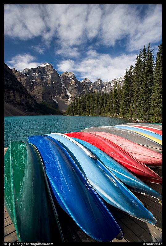 Colorful canoes stacked on the boat dock, Lake Moraine, morning. Banff National Park, Canadian Rockies, Alberta, Canada