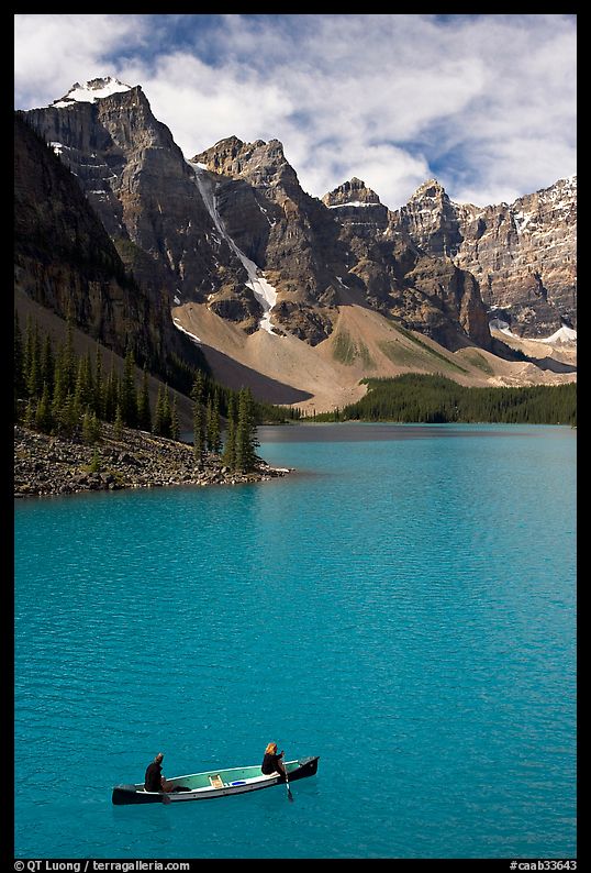 Canoeists below  Wenkchemna Peaks, Moraine Lake, mid-morning. Banff National Park, Canadian Rockies, Alberta, Canada
