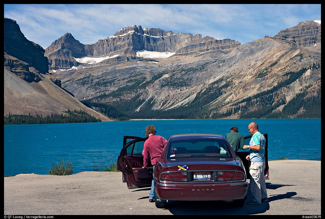 Visitors stepping out of a car next to Bow Lake. Banff National Park, Canadian Rockies, Alberta, Canada