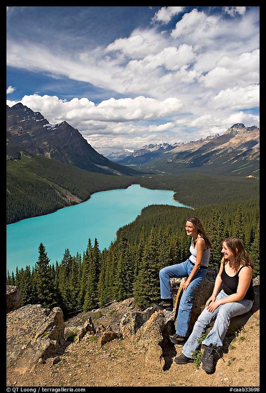 Women sitting on a rook overlooking Peyto Lake. Banff National Park, Canadian Rockies, Alberta, Canada