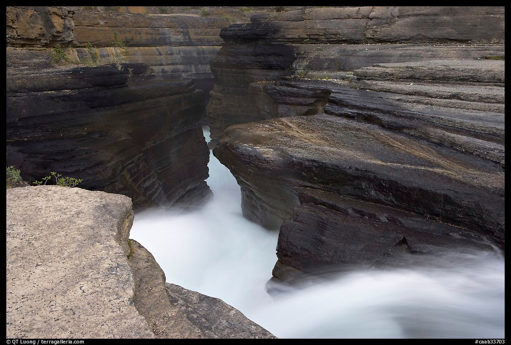River flowing through narrow rock gorge, Mistaya Canyon. Banff National Park, Canadian Rockies, Alberta, Canada