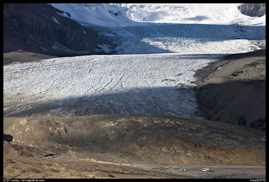 Base of Athabasca Glacier with cars parked on lot. Jasper National Park, Canadian Rockies, Alberta, Canada