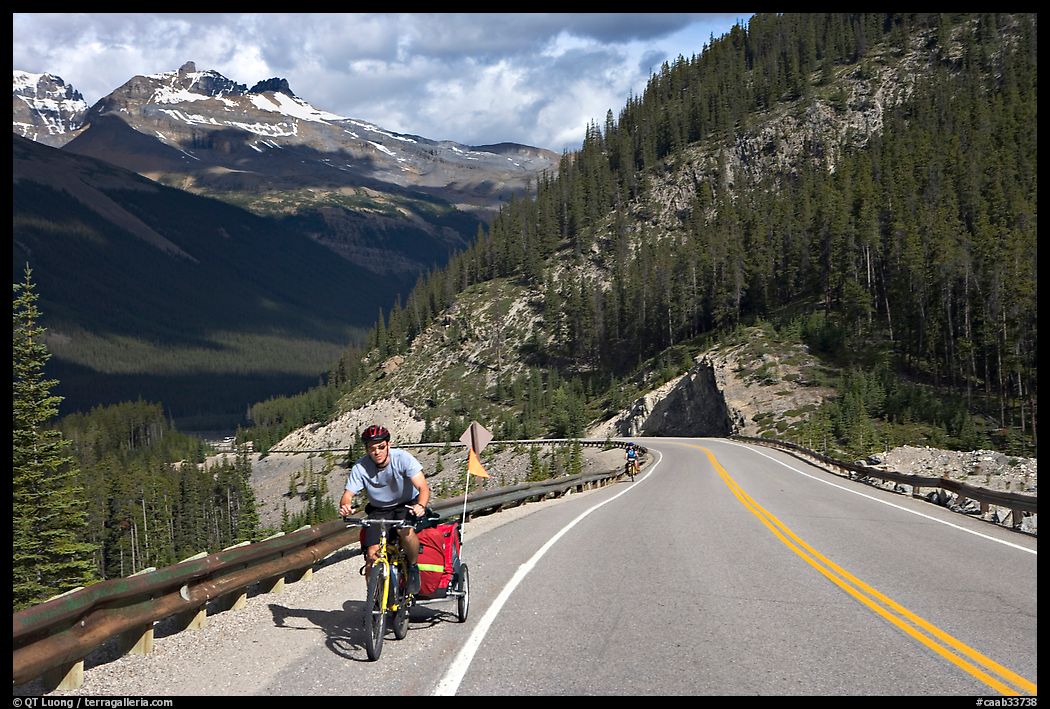 Cyclist with tow, Icefieds Parkway. Jasper National Park, Canadian Rockies, Alberta, Canada