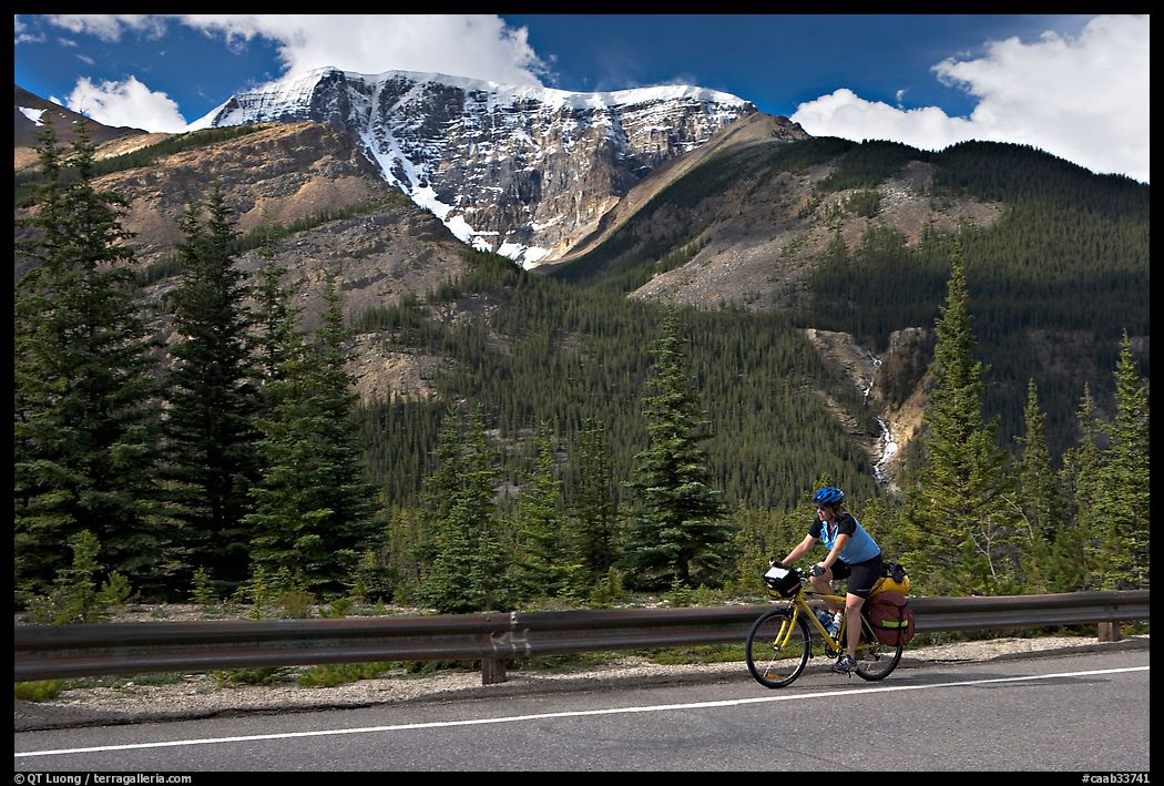 Woman cycling the Icefields Parkway. Jasper National Park, Canadian Rockies, Alberta, Canada
