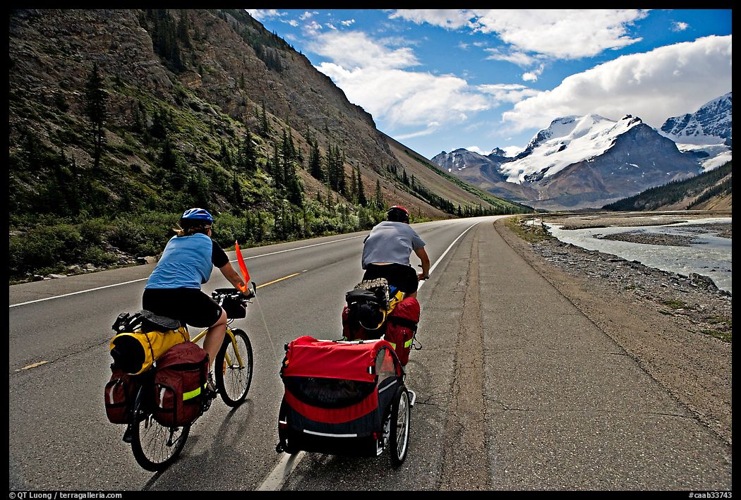 Couple cycling the Icefields Parkway. Jasper National Park, Canadian Rockies, Alberta, Canada