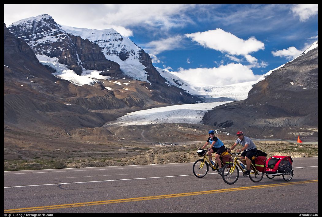 Cyclists on the Icefields Parkway in front of the Athabasca Glacier. Jasper National Park, Canadian Rockies, Alberta, Canada