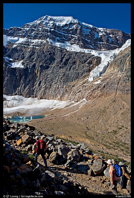 Hikers on trail below the face of Mt Edith Cavell. Jasper National Park, Canadian Rockies, Alberta, Canada