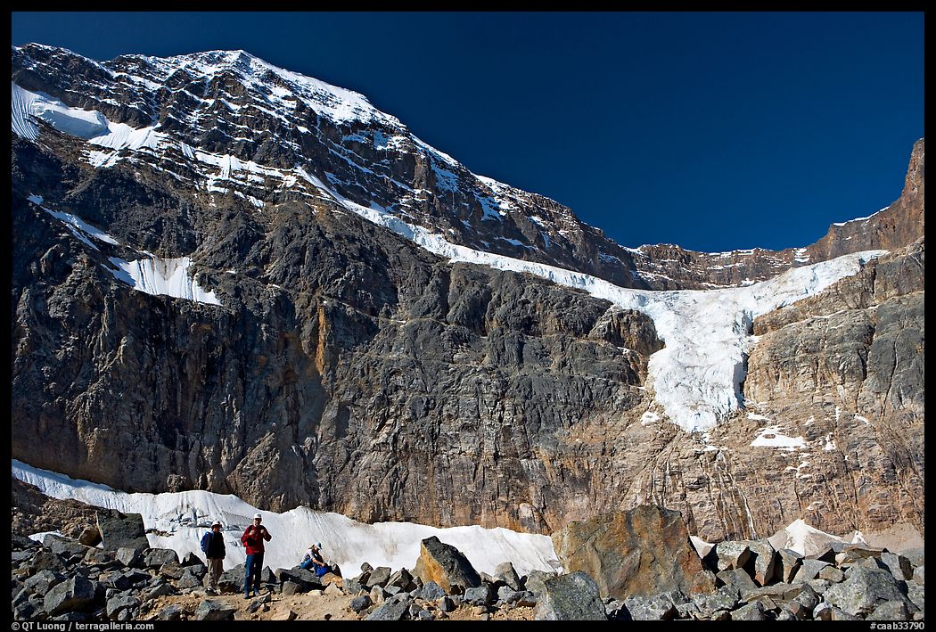 Hikers on a moraine below Mt Edith Cavell, morning. Jasper National Park, Canadian Rockies, Alberta, Canada