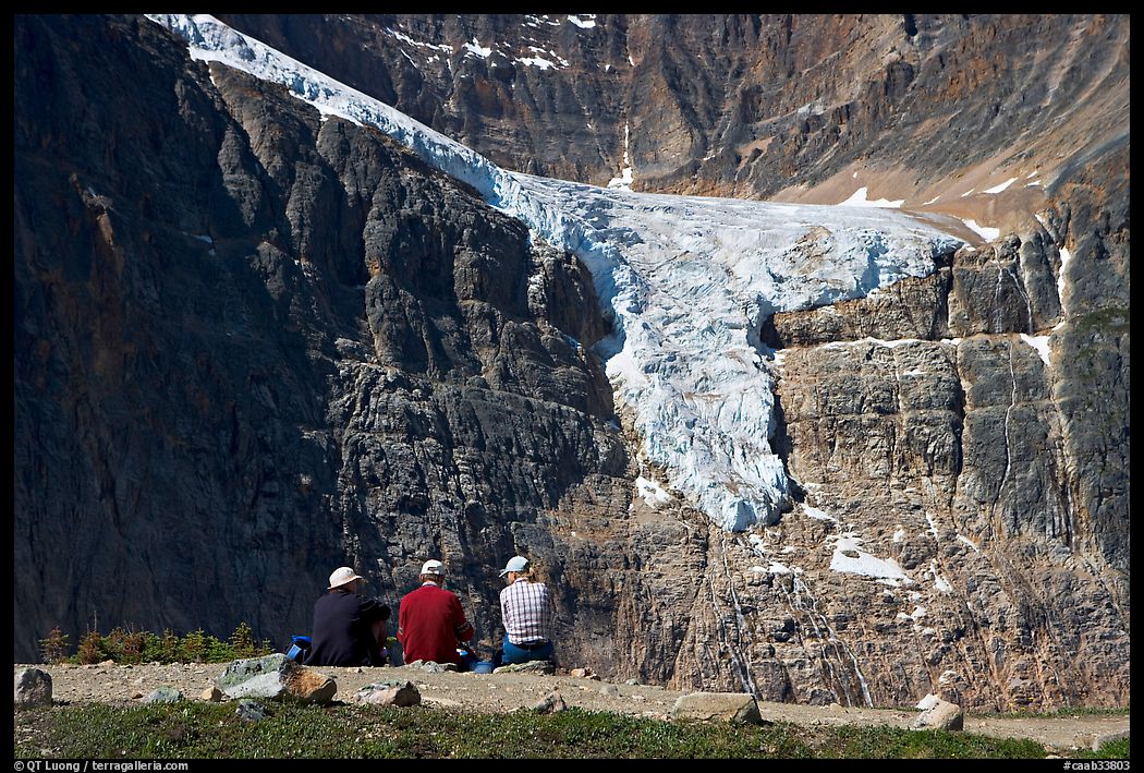 Hikers looking at a hanging glacier on  Mt Edith Cavell. Jasper National Park, Canadian Rockies, Alberta, Canada