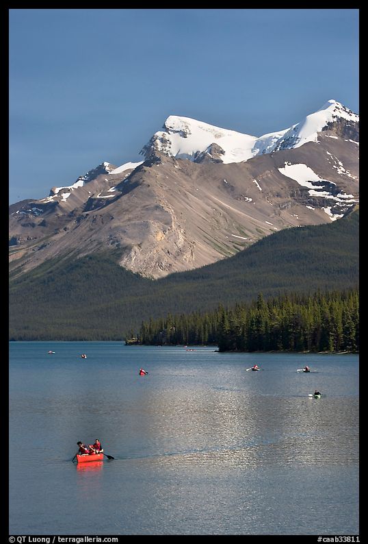 Red canoe on Maligne Lake, afternoon. Jasper National Park, Canadian Rockies, Alberta, Canada