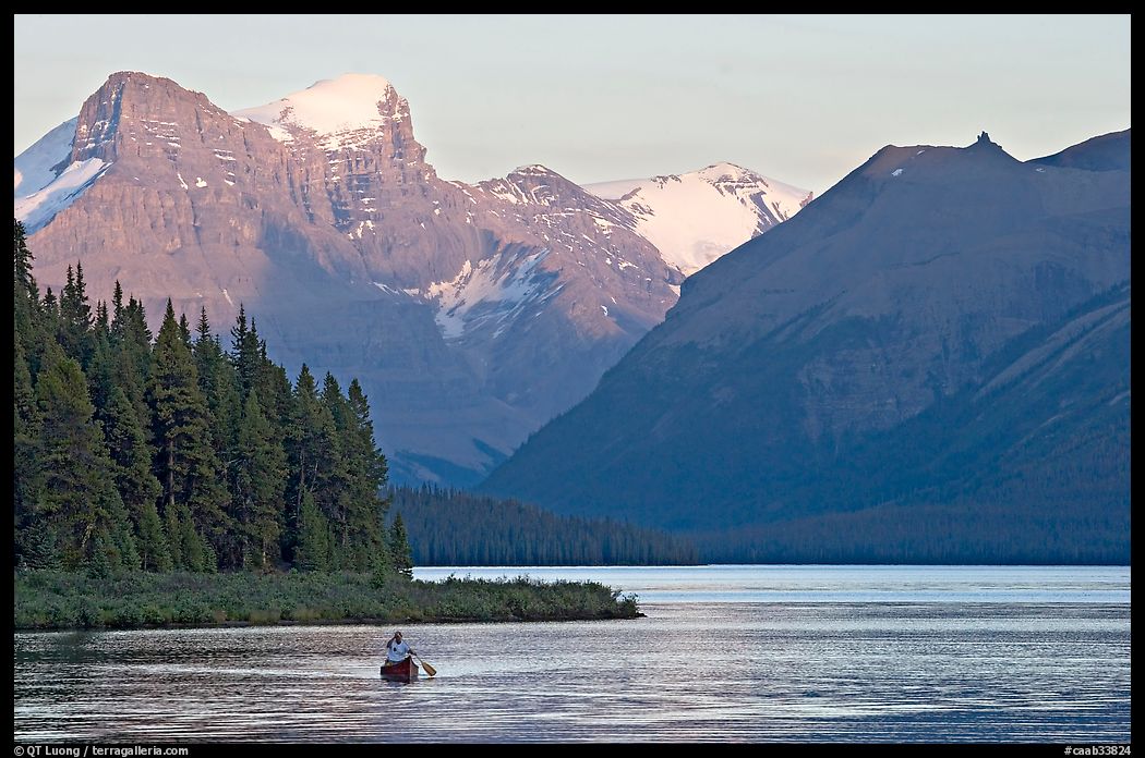Canoist paddling on Maligne Lake at sunset. Jasper National Park, Canadian Rockies, Alberta, Canada