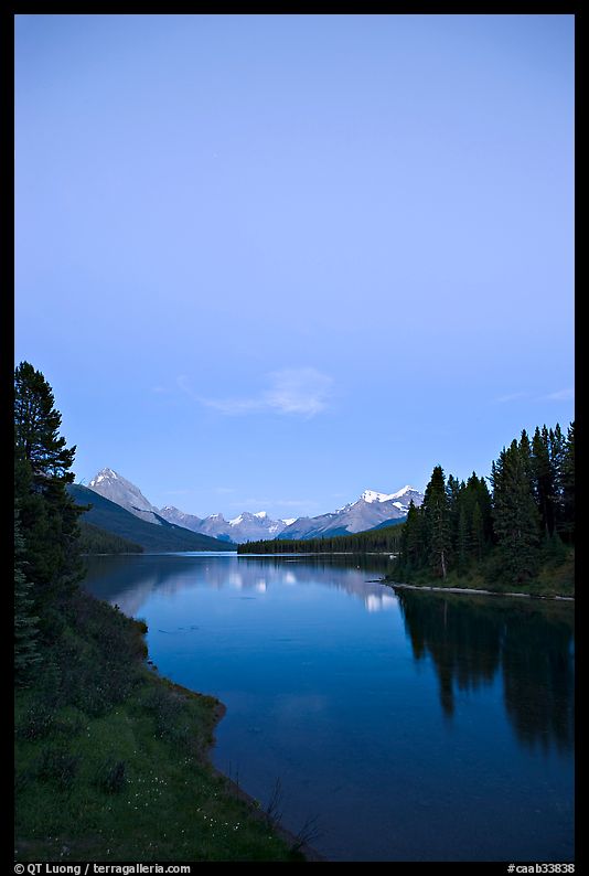 Maligne Lake from the outlet of the Maligne River, blue dusk. Jasper National Park, Canadian Rockies, Alberta, Canada