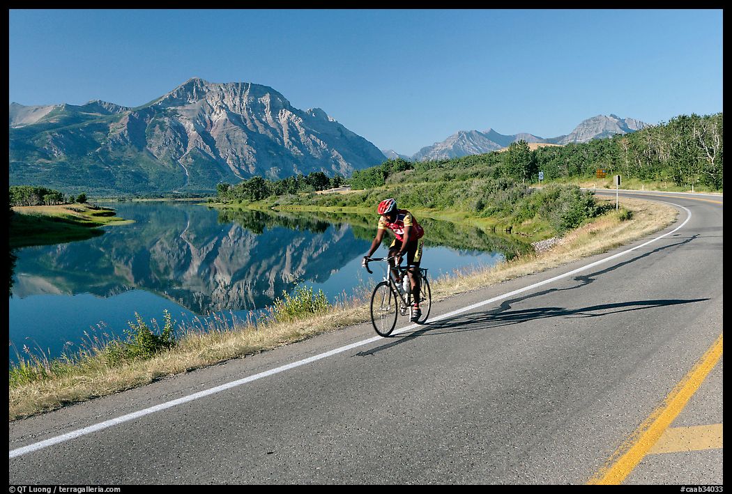 Cyclist next to Lower Waterton Lake. Waterton Lakes National Park, Alberta, Canada