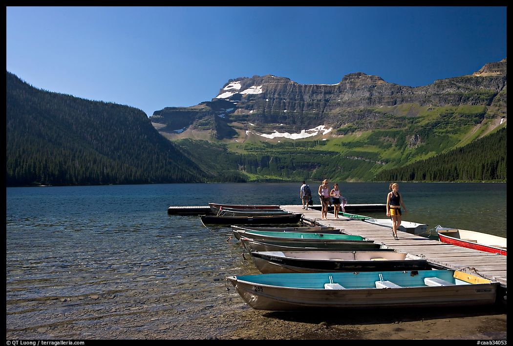 Dock and small boats, with visitors walking down, Cameron Lake. Waterton Lakes National Park, Alberta, Canada